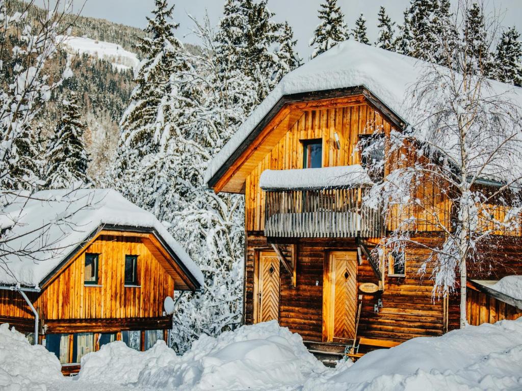 a log cabin in the snow with snow covered trees at Kreischberg W9 in Kaindorf Süd