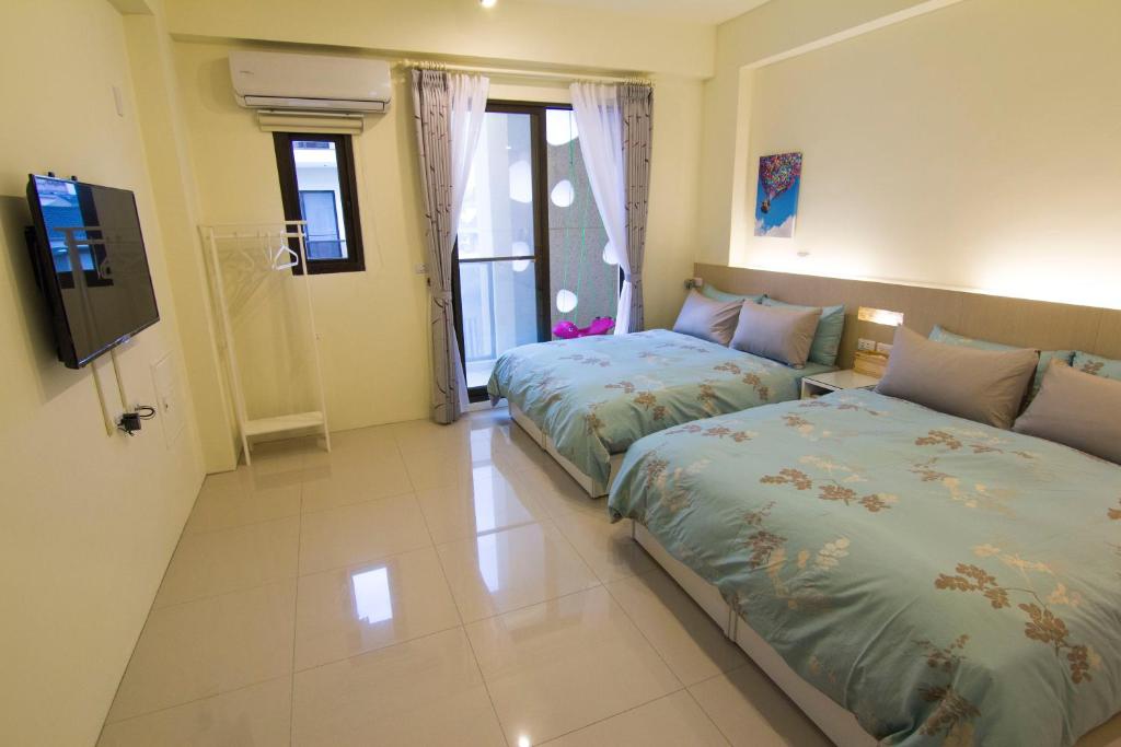 Letto o letti in una camera di 充電樁 羅東木村電梯民宿Luodong Tree BnB 雲朵朵二館 近週三清溝 免費洗衣機 烘衣機 星巴克咖啡豆 國旅卡特約店