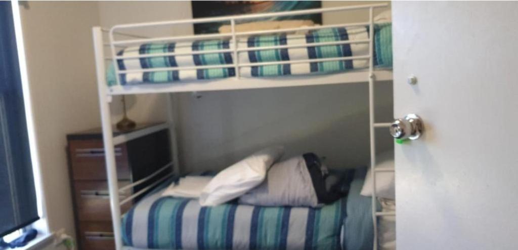 a bedroom with a bunk bed with a desk at Victoria room in Springvale