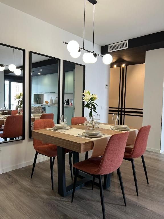 Hotel Marina Coastal Bliss Málaga centro, a dining room with a wooden table and chairs at Marina Coastal Bliss Málaga centro in Málaga