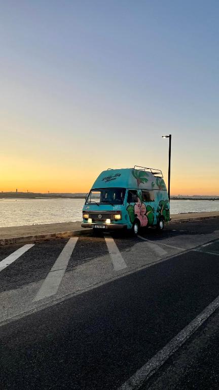 a blue van parked on the side of a road at Campervan Dory in Lisbon
