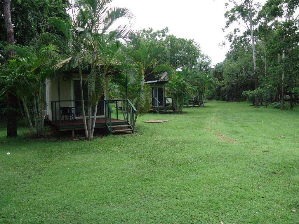 a small house in a field with a yard at Pandanus on Litchfield in Batchelor