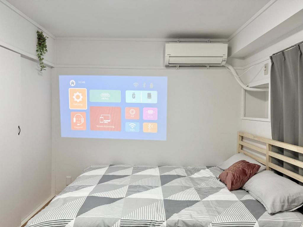 a room with a bed and a projection screen at Shinjuku Waseda home4 in Tokyo