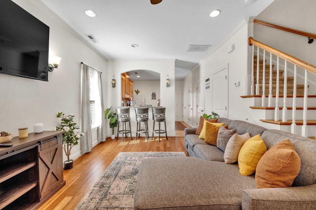a living room with a couch and a tv at Cozy 2B Townhouse - King Bed in Concord