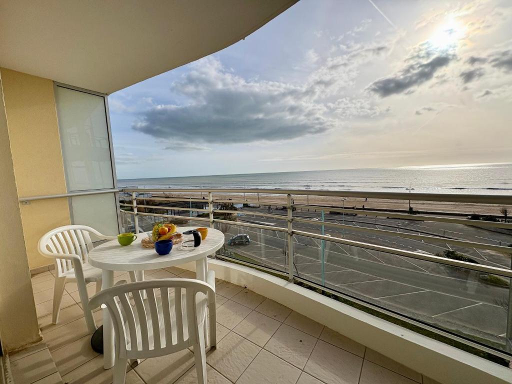 un balcon avec une table et des chaises et une vue sur la plage dans l'établissement Appartement lumineux à 50m de la plage avec balcon - 5 personnes, Saint-Jean-de-Monts - FR-1-323-298, à Saint-Jean-de-Monts