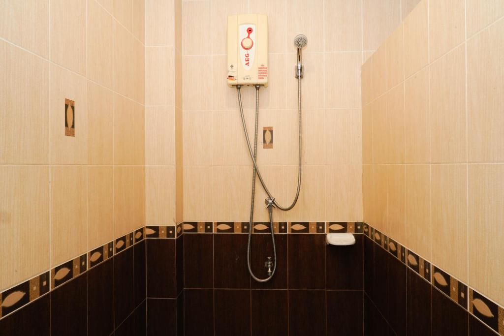 a shower stall in a bathroom with aitizer at Katanoi Resort in Kata Beach