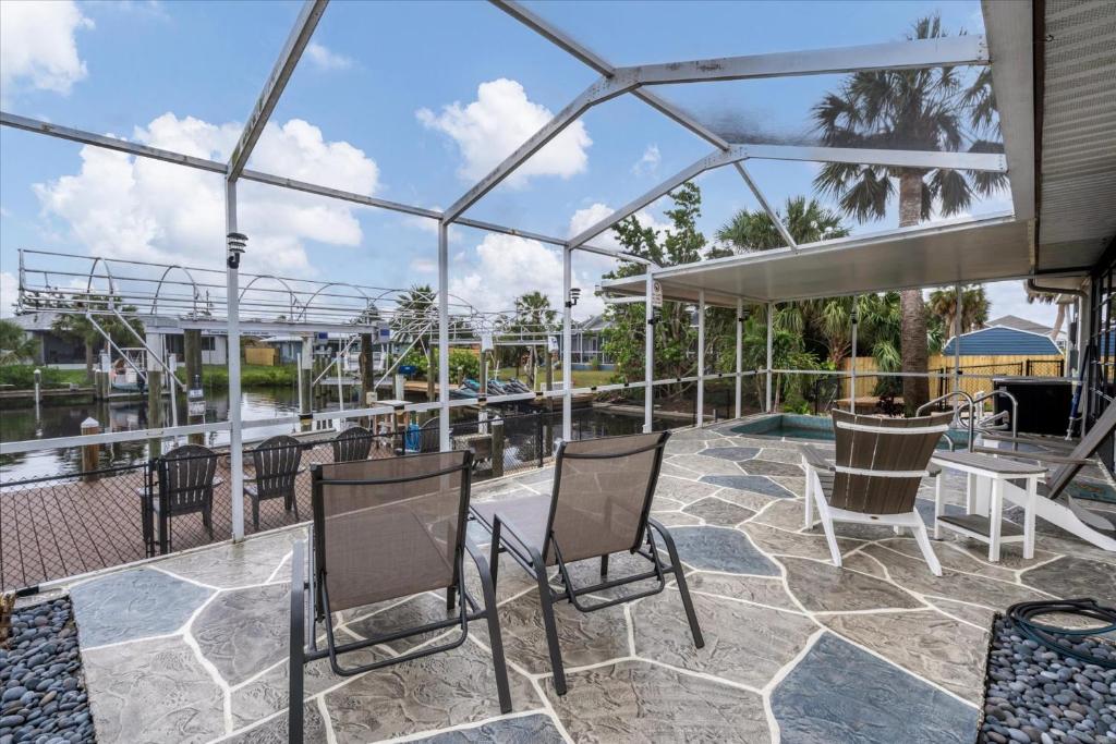 a patio with chairs and a table and a pool at BRC18614 in Port Charlotte