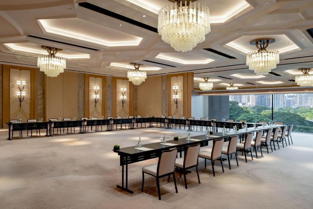 a large banquet hall with a long table and chairs at Dusit Thani Bangkok in Bangkok