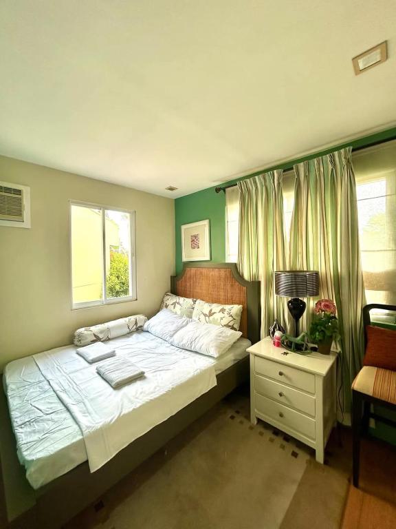 a bedroom with a large bed and a window at VIP 4-Bedroom House in Butuan