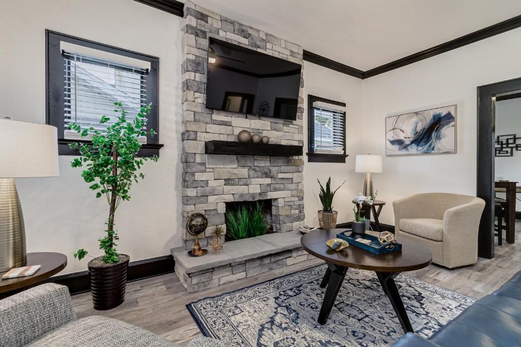 a living room with a fireplace and a tv at The Palm House Near Lake Hollingsworth & FSC in Lakeland