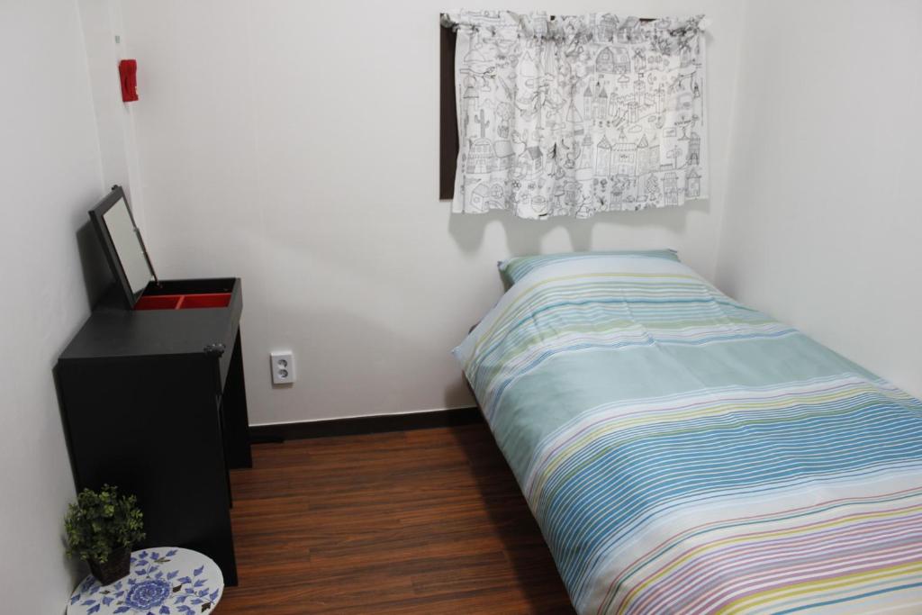 Postel nebo postele na pokoji v ubytování Jiwoljang Guesthouse