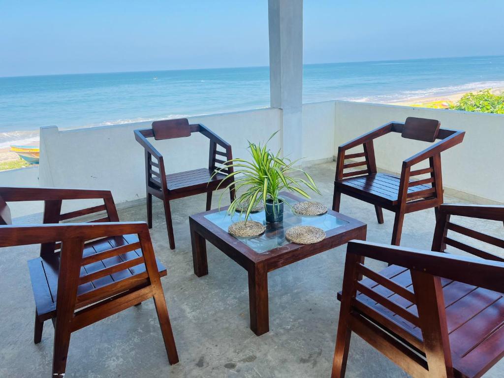 a group of chairs and a table with a plant at Chanco Beach Hotel and Coworking - Negombo in Negombo