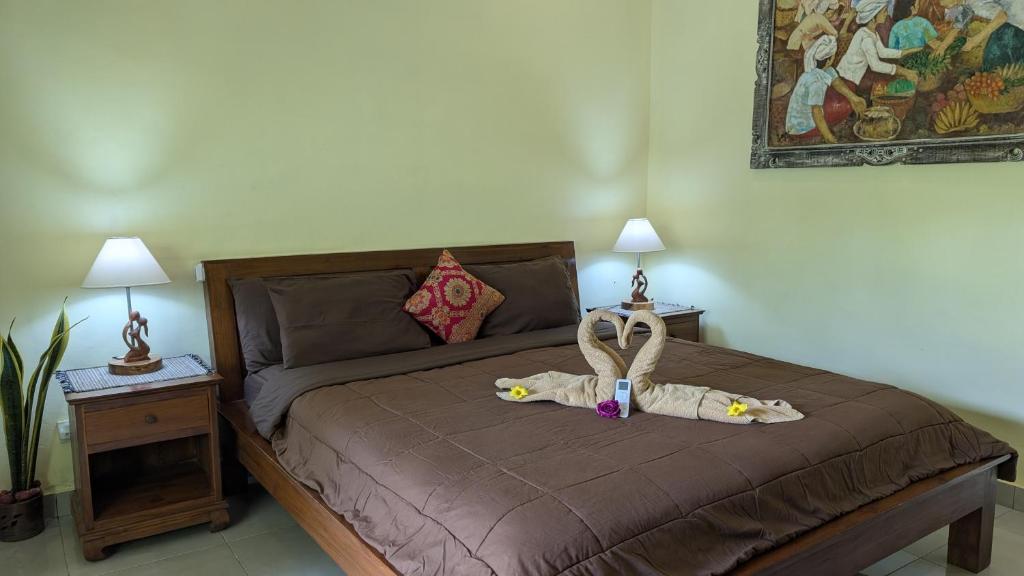 Postel nebo postele na pokoji v ubytování Krisda Ubud Guest House