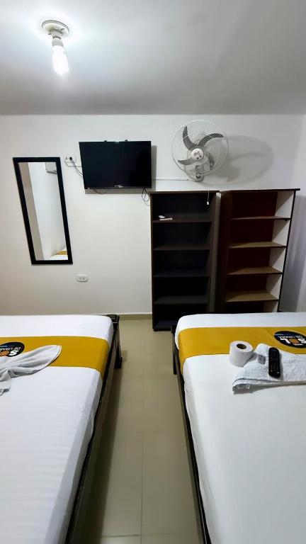 Postel nebo postele na pokoji v ubytování Hotel sol de uraba