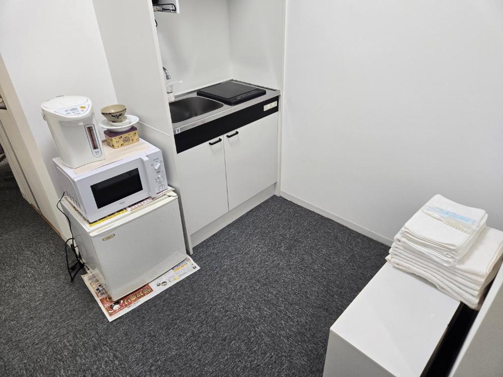 Kuchyň nebo kuchyňský kout v ubytování 旅館やすらぎ