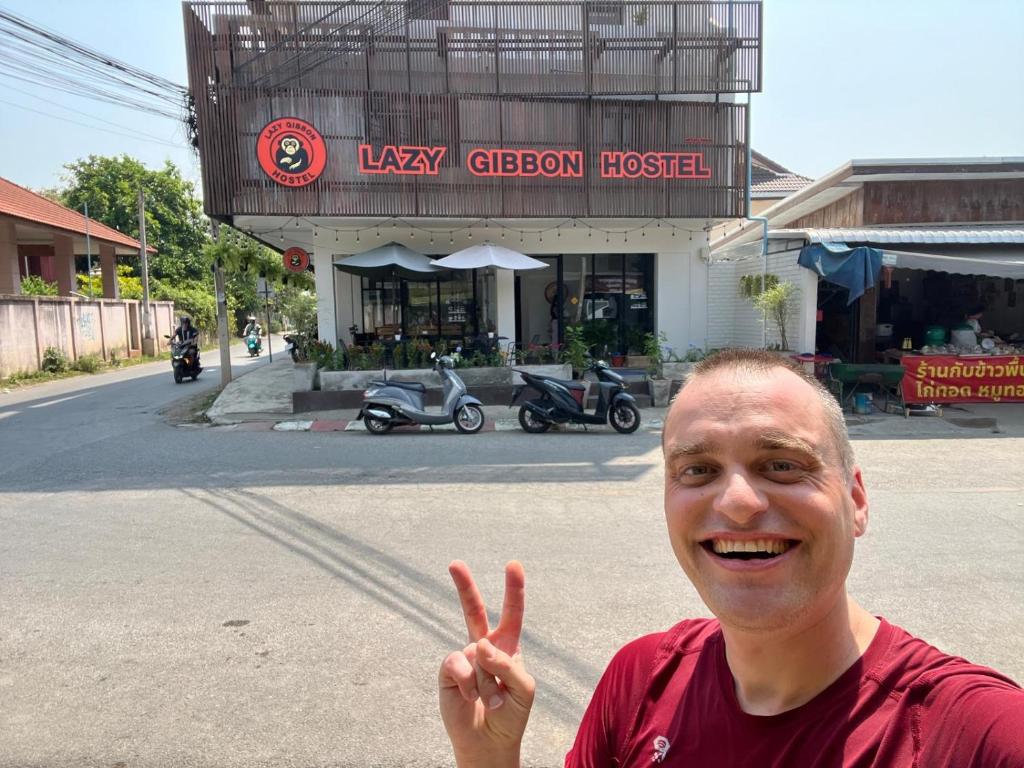 a man giving the peace sign with his finger at Lazy Gibbon 2 Chiang Mai - Haiya in Chiang Mai
