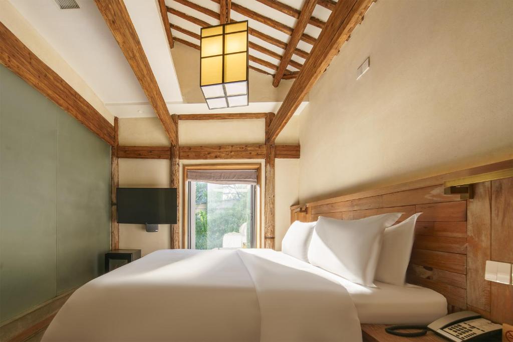 Postel nebo postele na pokoji v ubytování Huangshan Shanshui Boutique Hotel Liyang Scenic Area