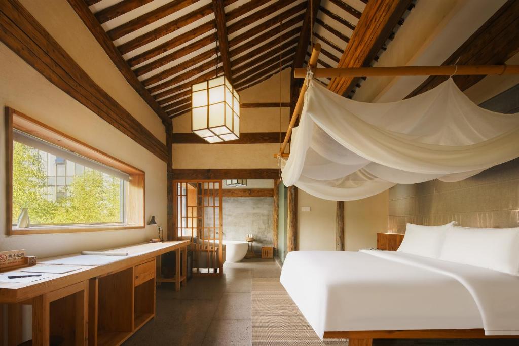 Postel nebo postele na pokoji v ubytování Huangshan Shanshui Boutique Hotel Liyang Scenic Area
