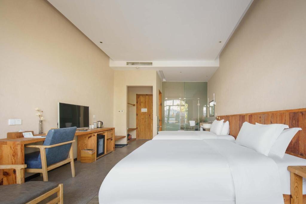 Postel nebo postele na pokoji v ubytování Huangshan Shanshui Boutique Hotel Liyang Scenic Area