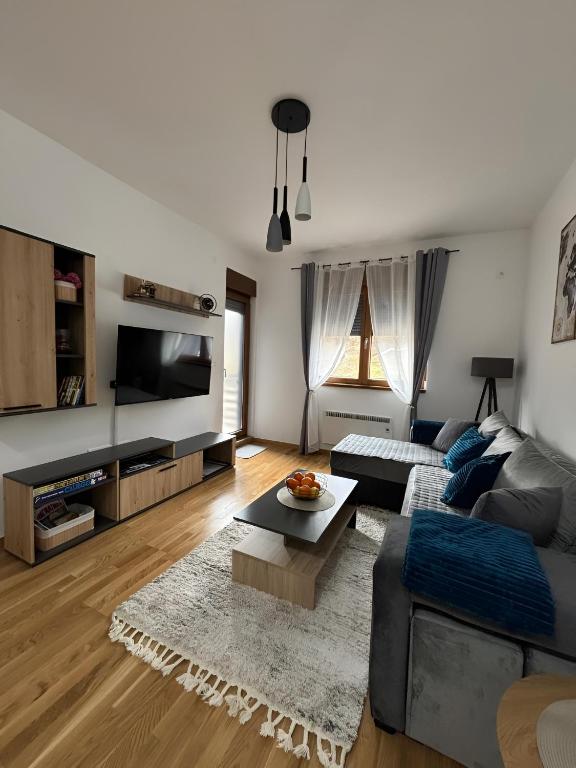 a living room with a couch and a table at Tanasković Home Zlatibor in Zlatibor