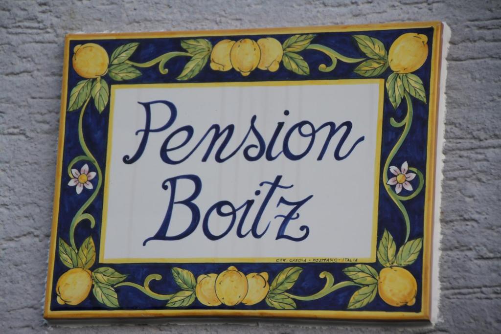 ein Schild für ein Restaurant mit Zitronen drauf in der Unterkunft Pension Boitz in Rust