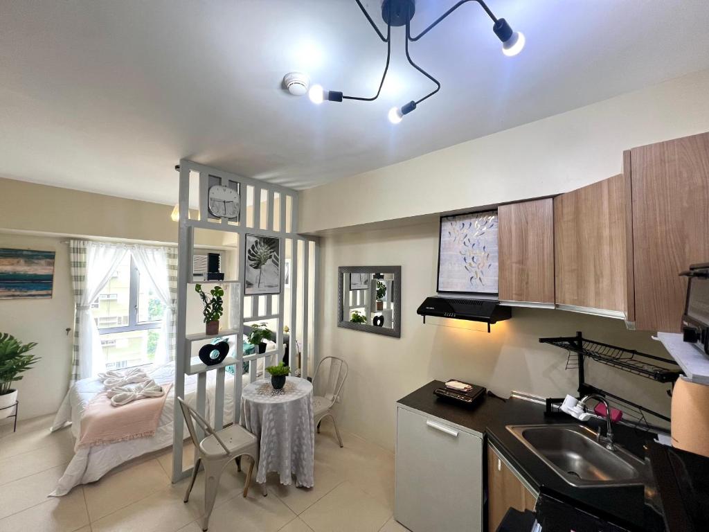 a kitchen with a sink and a table in a room at IT Park + fast net in Cebu City