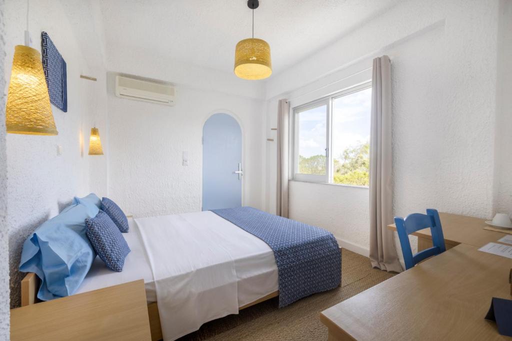 Postel nebo postele na pokoji v ubytování Lassion Hotel