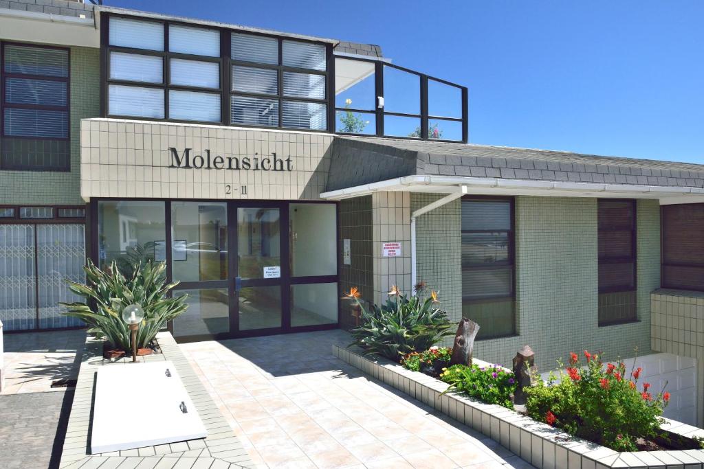 a building with a sign that reads molestation at Molensicht No. 8 in Swakopmund