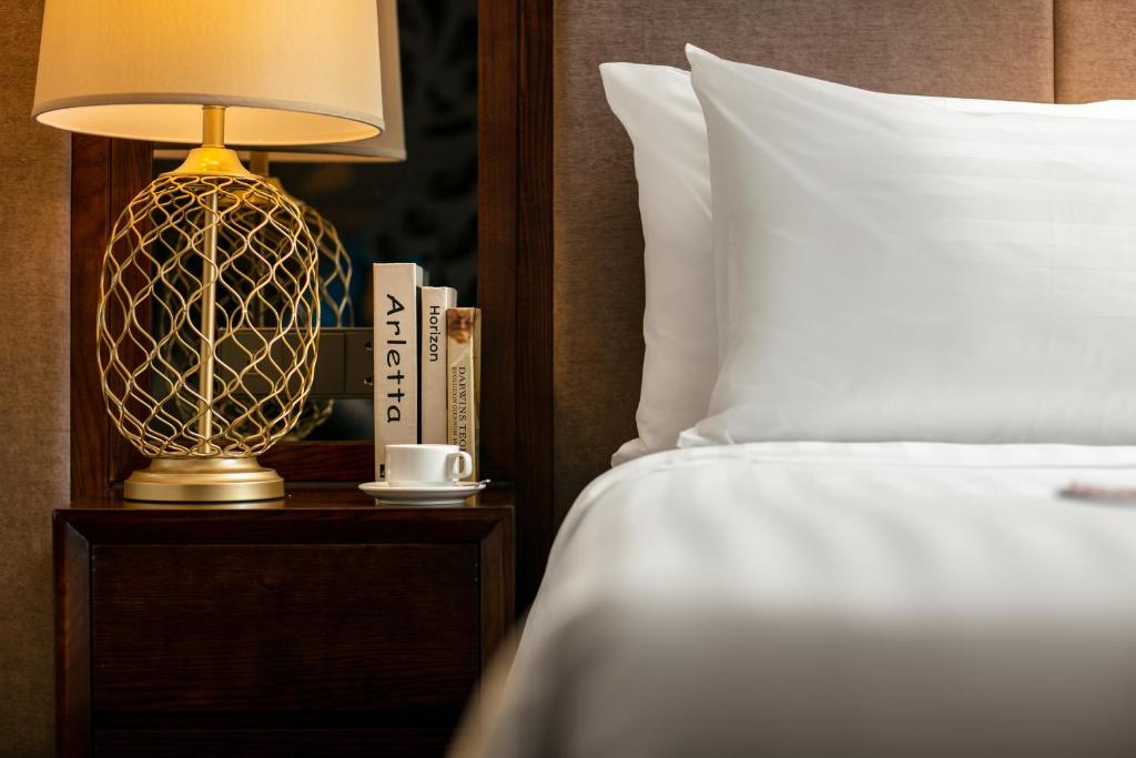 Postel nebo postele na pokoji v ubytování Ping Diamond Hotel Hanoi