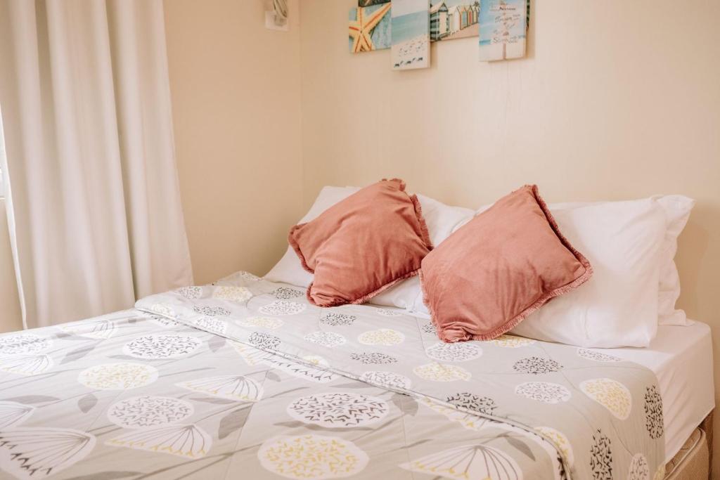 una cama con dos almohadas encima en A Serene Cozy Oasis, en Iloilo City
