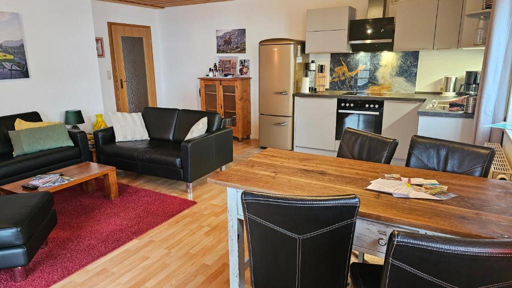 a kitchen and living room with a table and chairs at Jungholz Erlebnis in Jungholz