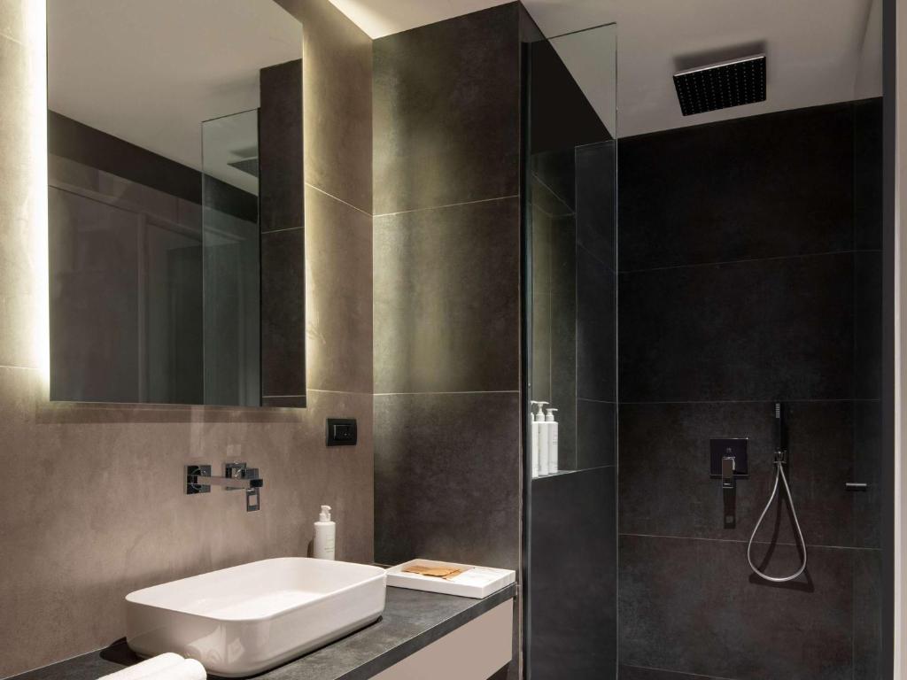 a bathroom with a sink and a shower at Swissôtel Resort Bodrum Beach in Turgutreis