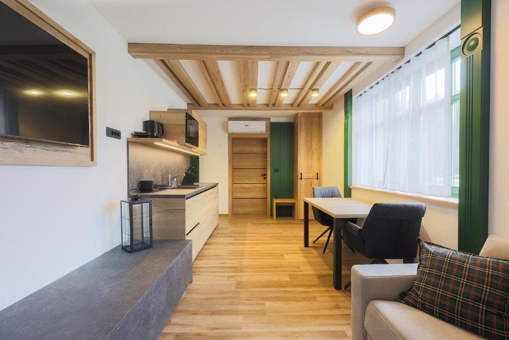 a living room with a couch and a table at Vila Savica Bled in Bled