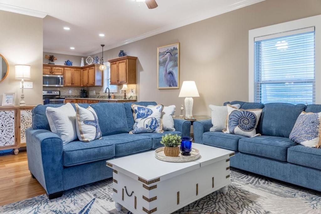 a living room with blue couches and a coffee table at The Rookery III 5008 cottage in Gulf Shores