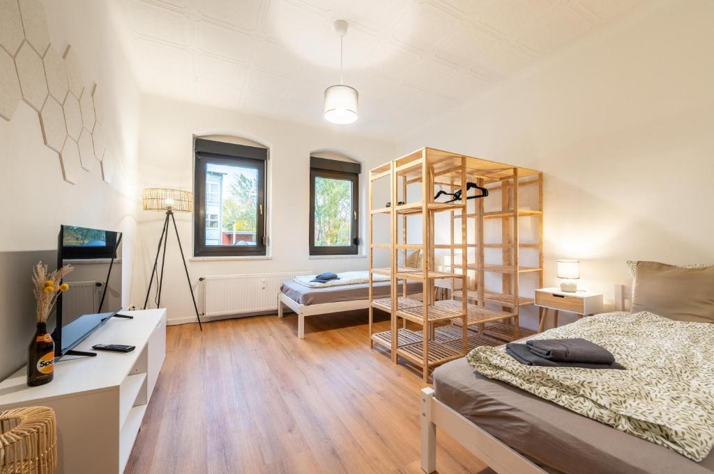 a room with a bed and a book shelf in it at Monteurwohnung Dresden-Klotzsche I in Dresden