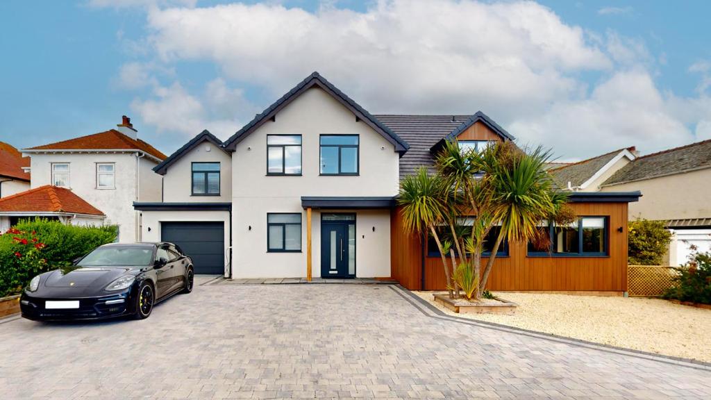 a car parked in front of a house at 105 The Beach House in Penrhyn Bay