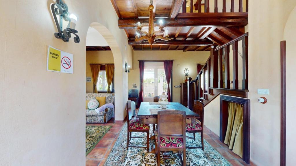 a kitchen with a table and chairs in a room at O toxal in Monforte de Lemos