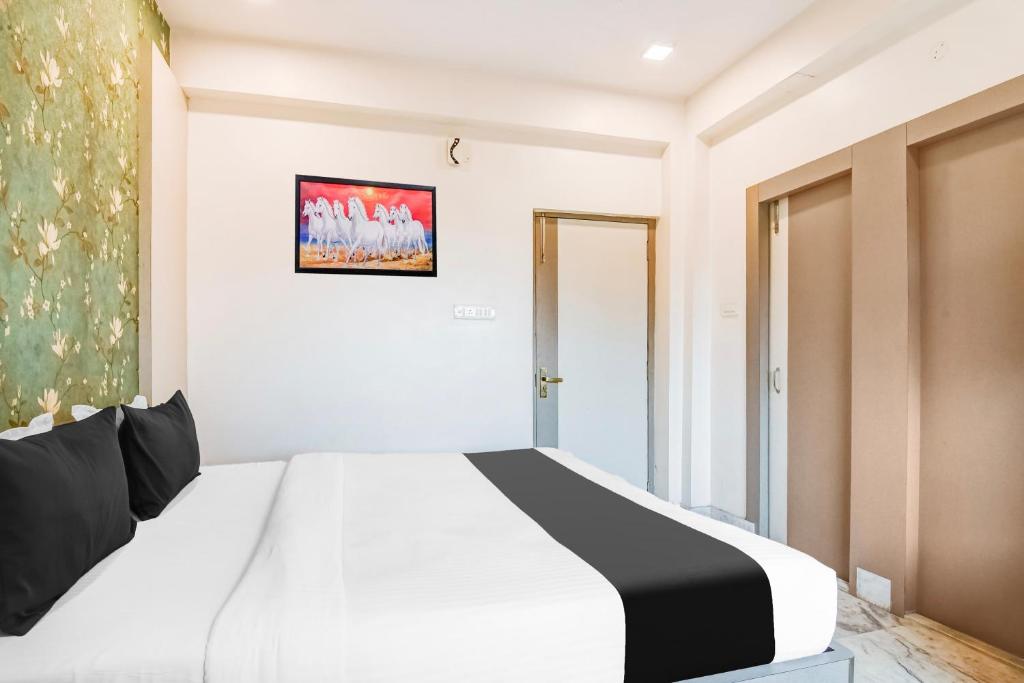 Postel nebo postele na pokoji v ubytování Hotel O Tagore Park