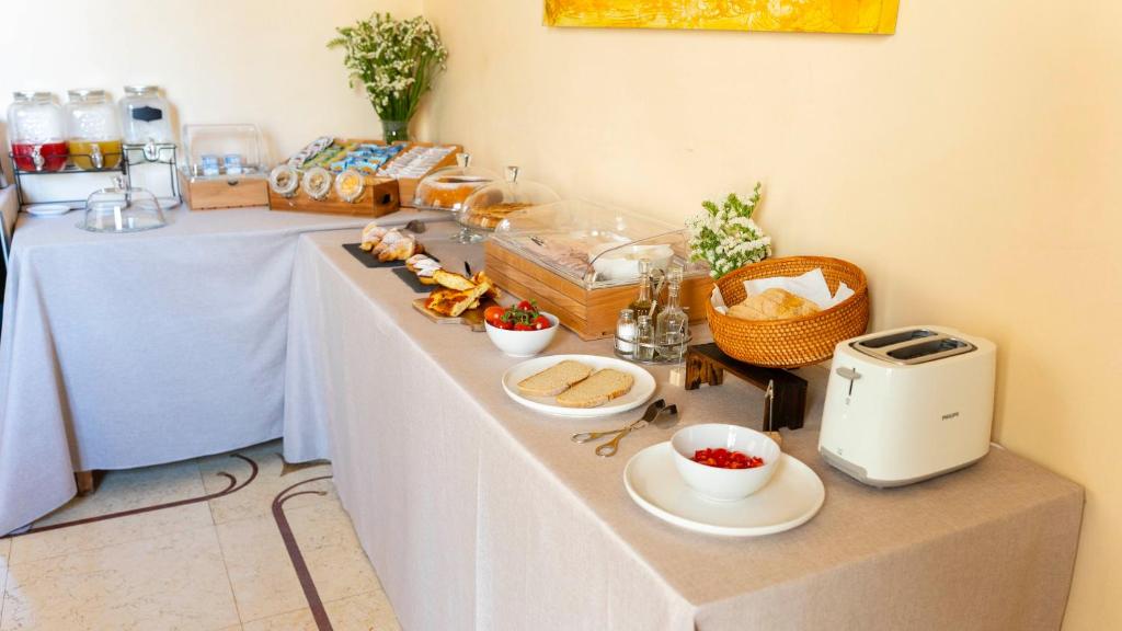 un tavolo con cibo e pane sopra di Palazzo Insula a Gallipoli