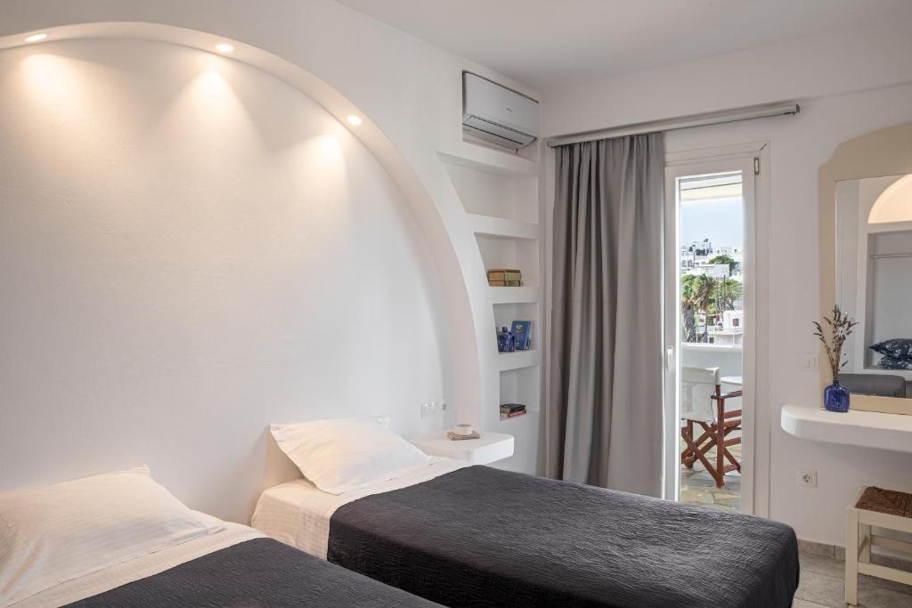 Postel nebo postele na pokoji v ubytování Aloni Hotel & Suites