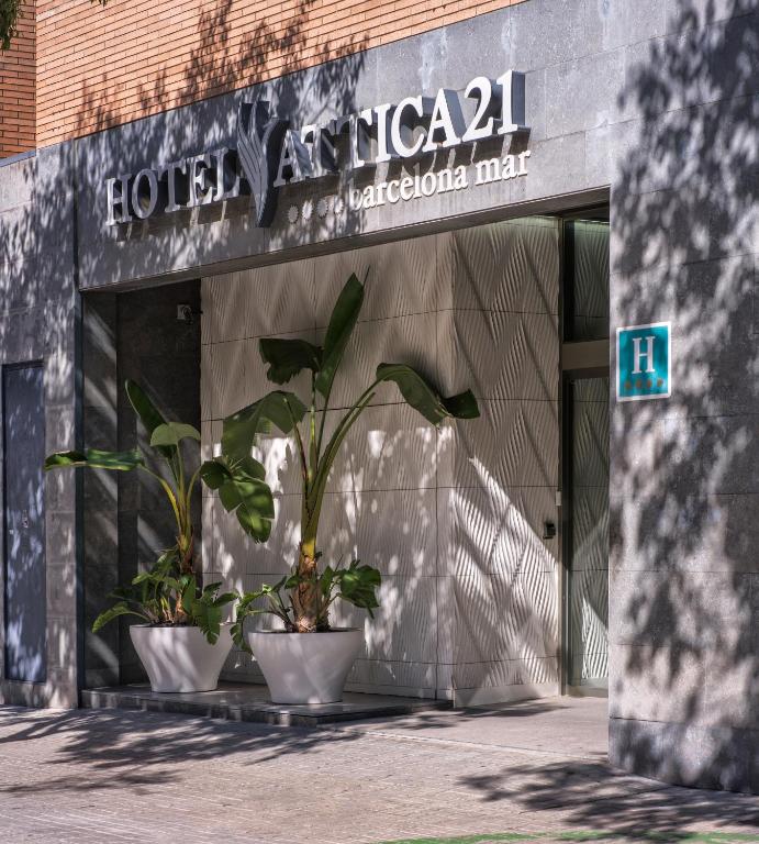 two potted plants sitting in front of a building at Attica 21 Barcelona Mar in Barcelona