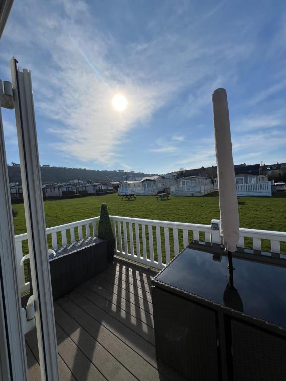a balcony with a couch and a table on a deck at Pebble Ridge hoilday home in Northam