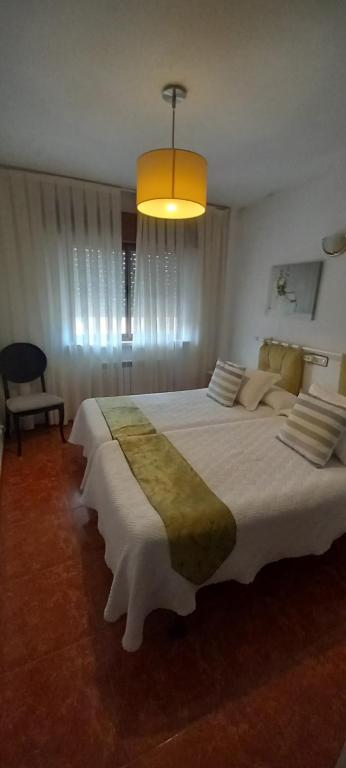 Postel nebo postele na pokoji v ubytování Hostal Las Cadenas