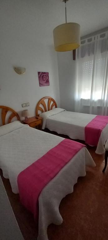 Postel nebo postele na pokoji v ubytování Hostal Las Cadenas