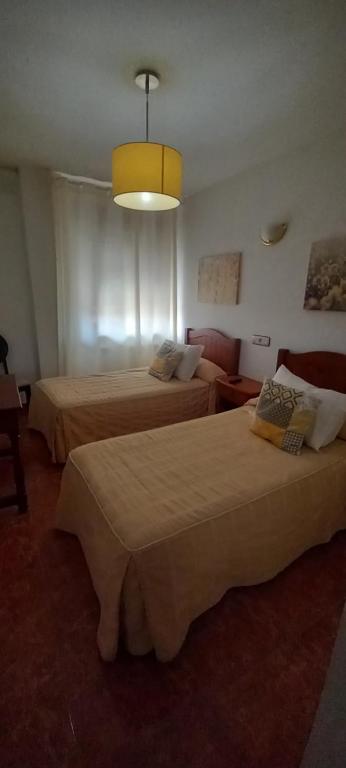 Postel nebo postele na pokoji v ubytování Hostal Las Cadenas