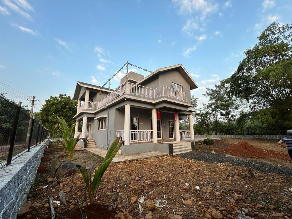a house that is sitting in a yard at Huvazeel Villa - Murbad for Monthly rental only in Saralgaon