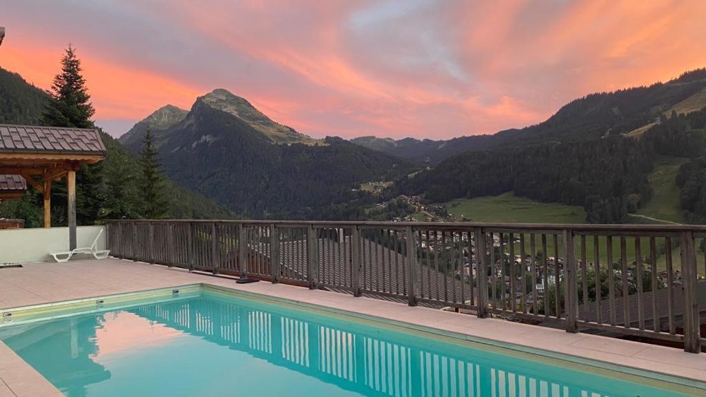 a swimming pool with a view of mountains at Chalet Pip - Modern chalet with breathtaking views in Morzine