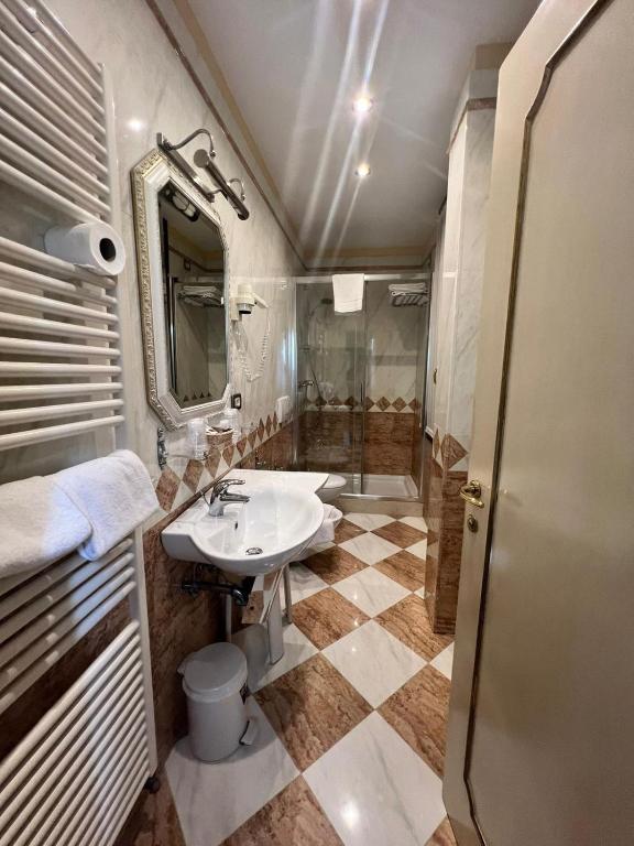 a bathroom with a sink and a shower at Hotel Ca' Dogaressa in Venice