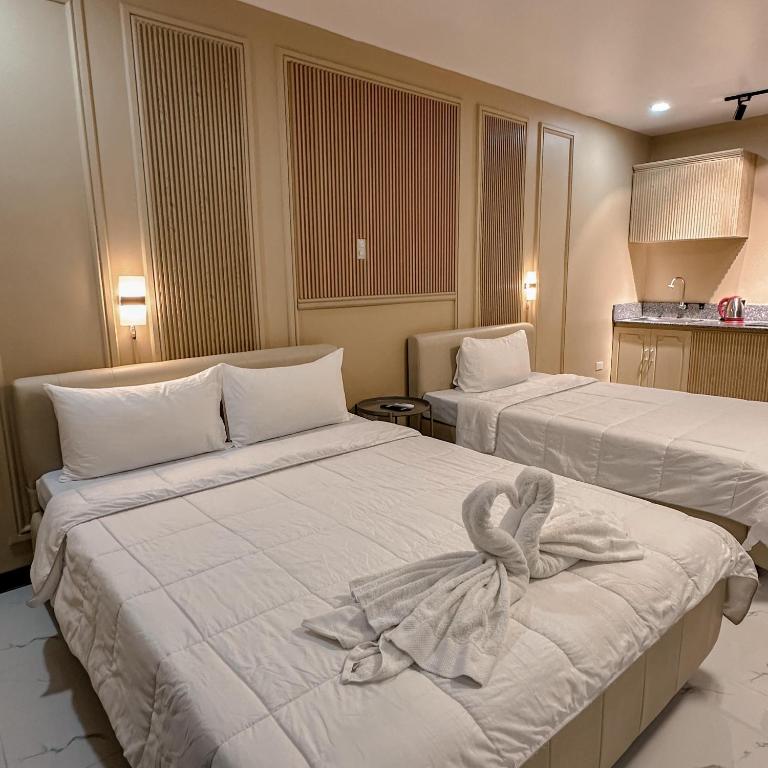 Postel nebo postele na pokoji v ubytování Clark CU Hotel