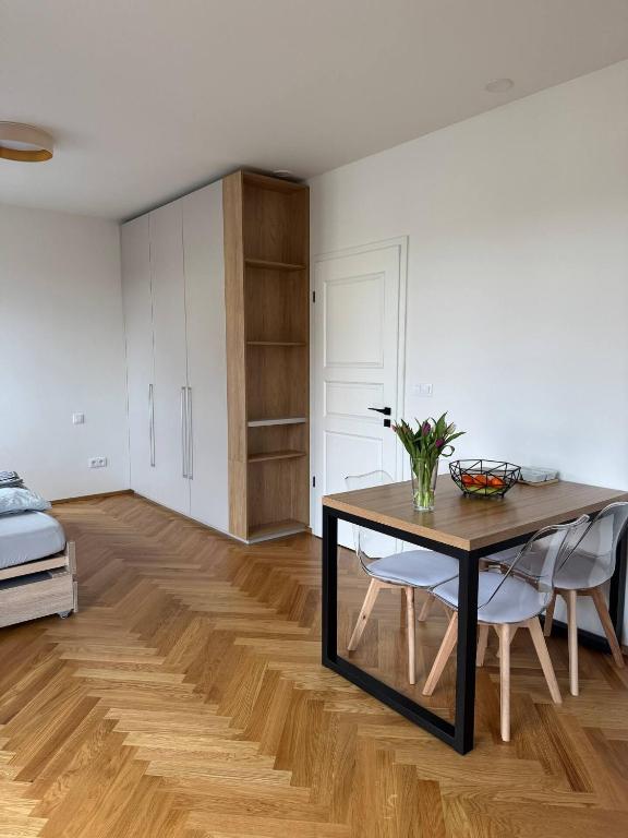 a room with a table and chairs and a bed at Rezidence Kotnov Tábor in Tábor